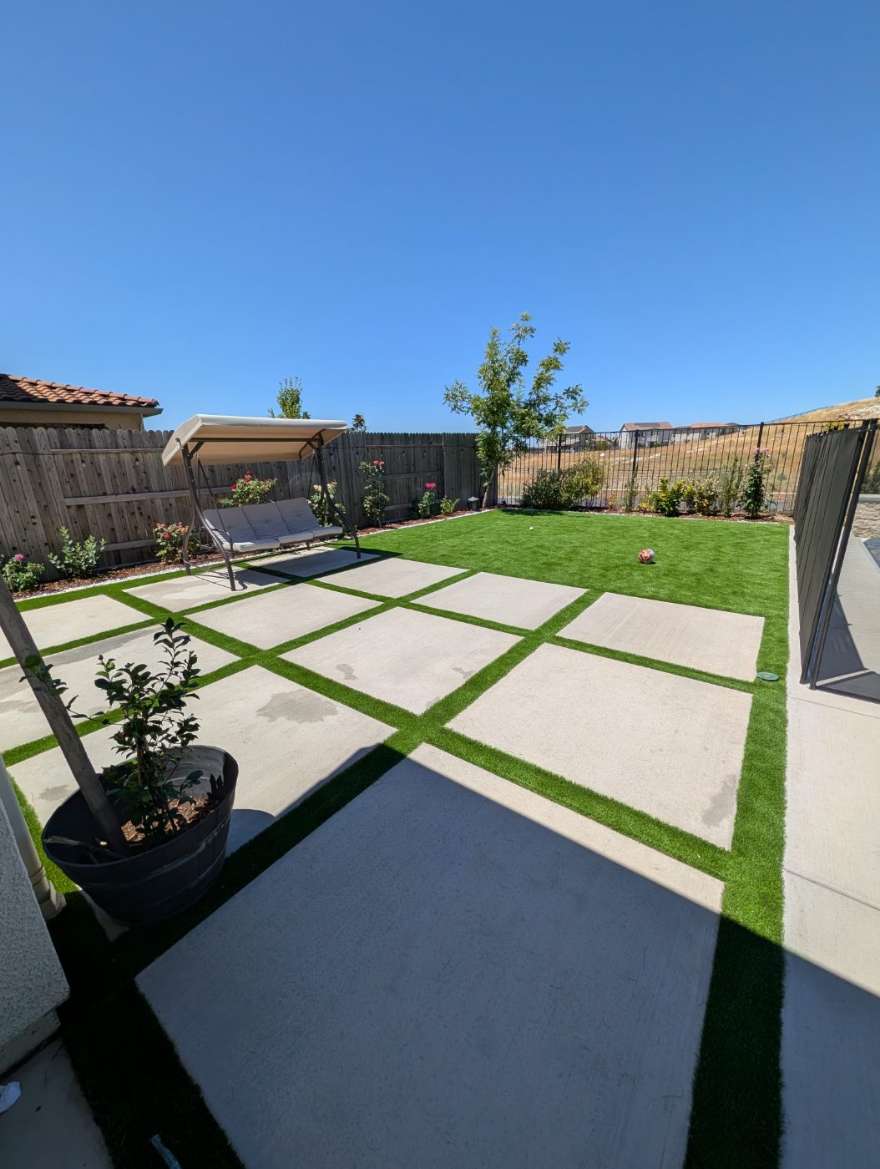 The fenced backyard with lawn, patio, and a shade swing