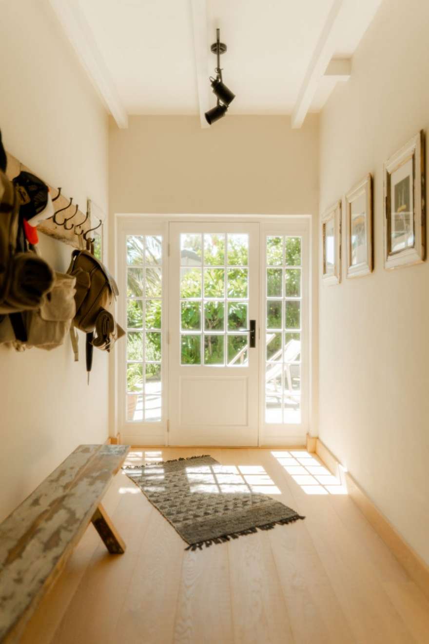 The sunlit front entry with coat hooks